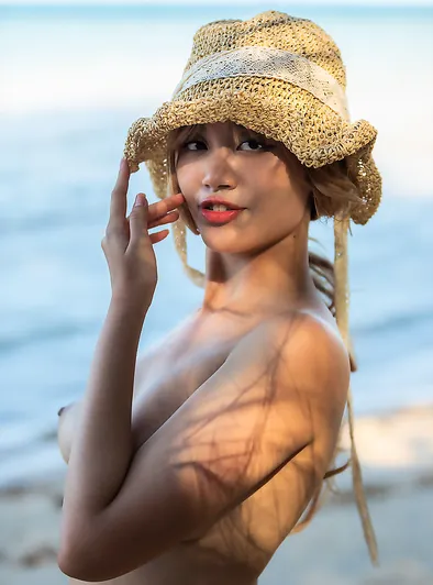 Danny Bends Over to Show Her Cute Pussy on the Beach