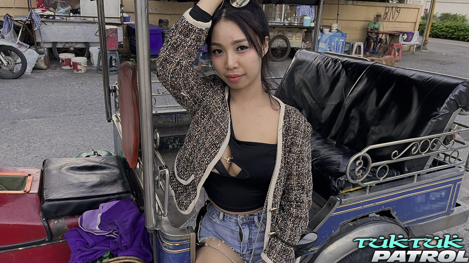 Thai bargirl on Walking Street next to tuktuk go-go stage in Pattaya nightlife
